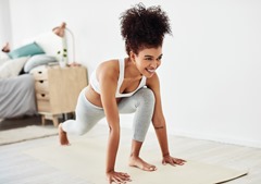 Shot of a fit young woman doing yoga at home