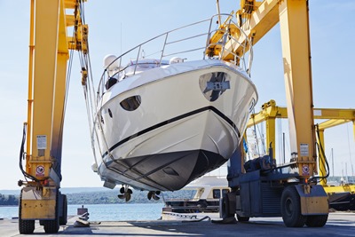 Yacht being dry docked at a shipyard